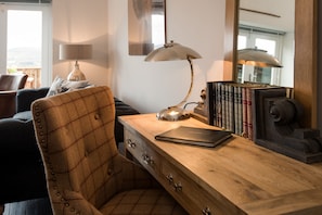 Byre - desk with tartan armchair in sitting room