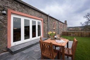 Byre - garden with outside seating area and bi-folding doors into the sitting room