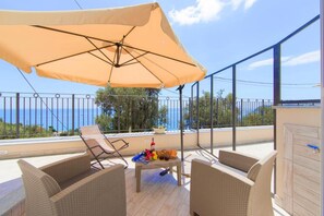 Outdoor terrace with chairs and sun ombrella