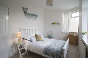 Bright main bedroom with lots of windows.