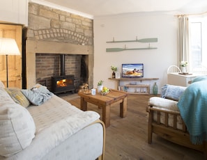 Cosy sitting room with a woodburner