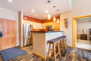 Kitchen featuring breakfast bar.