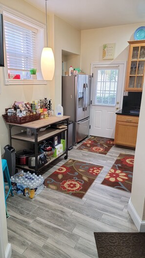 kitchen with complimentary bottle water, coffee and tea.