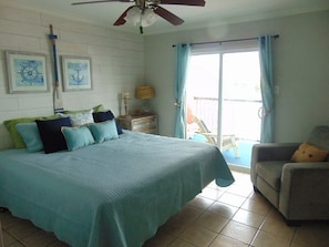 King sized bed - the decor follows through to the master with balcony doors
