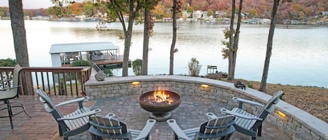 Viewing out into the cove from lower level stone patio. Mature trees w/ shade.