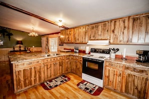 Full kitchen with stove/oven, refrigerator, coffeemaker and 2 dining areas.