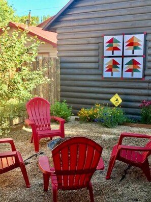 Private courtyard with covered porch, firepit, and charcoal BBQ grill 