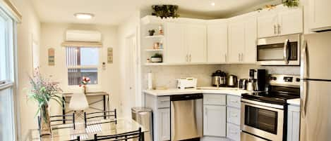 Kitchen fully stocked w/ tableware. Fridge, microwave, stove, oven, & dishwasher