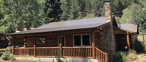 Cabin with National Forest behind it