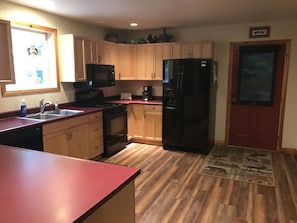 Large kitchen, new floors, paint, and Blinds!
