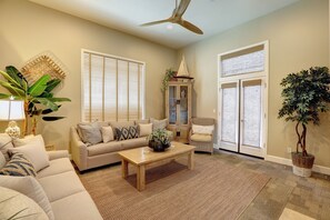 French doors open to patio. There is a glimpse of ocean view from front patio.