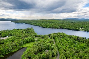 Private lake access with a dock in protected cove, and quiet surroundings on Sebec Lake.