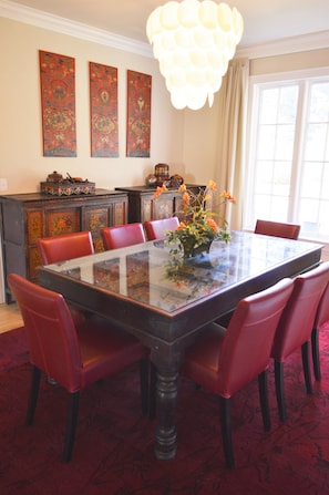 Formal dining room area surrounded by Tibetan furniture. 