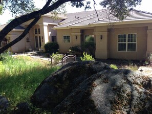 Front of home with views of Oak trees