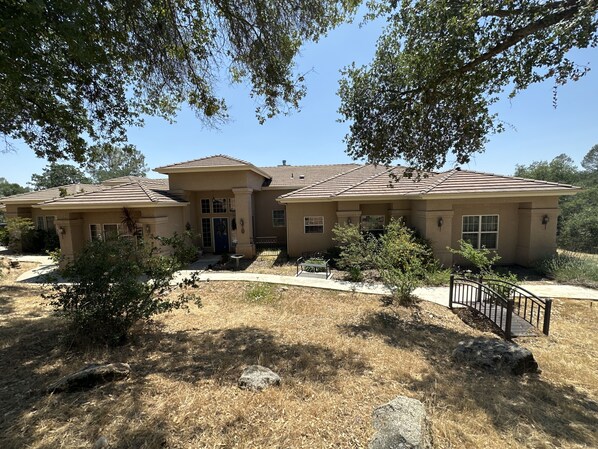 The front of our 3400 sqft Ranch Mediterranean home on 3 acres & seasonal creeks