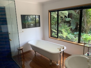 Full size clawfoot bath, shower with bush views in main bathroom.