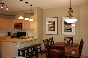 Dining room with 6 chairs and 3 bar stools