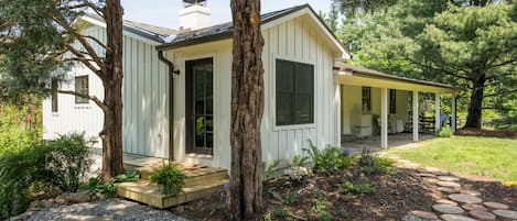 View of the cottage from parking with steps shown to mudroom or entry door.
