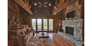 Cozy up next to the gorgeous stone fireplace while still enjoying spectacular views!