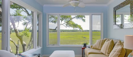 The sunroom is a great place to read a book, watch the changing tides, and see wildlife like egrets, deer, raccoons, and hopefully a dolphin swimming up the creek at high tide!