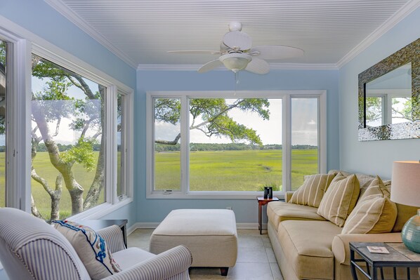The sunroom is a great place to read a book, watch the changing tides, and see wildlife like egrets, deer, raccoons, and hopefully a dolphin swimming up the creek at high tide!
