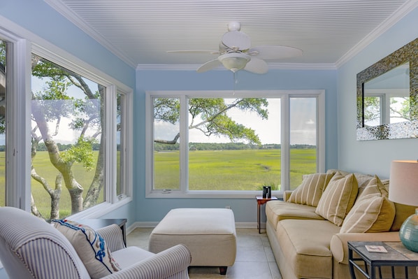 The sunroom is a great place to read a book, watch the changing tides, and see wildlife like egrets, deer, raccoons, and hopefully a dolphin swimming up the creek at high tide!