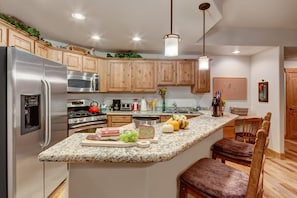 Gourmet open kitchen with breakfast bar seating