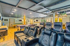 game room includes theater, pool table, air hockey, poker table, & shuffle board