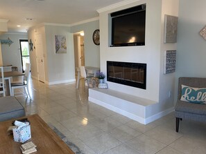 View from the back to from with Fireplace and large flat screen