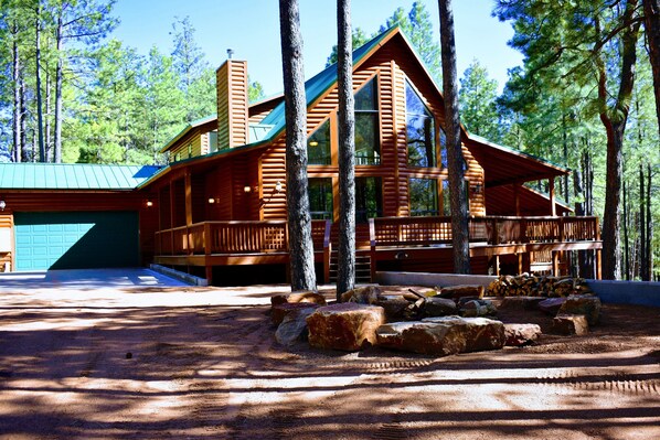 Front view with ample parking, large garage and fireplace.