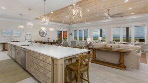Spacious great room with multiple seating areas looking out at Gulf of Mexico