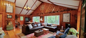 Comfy living room with massive leather sectional.  TV with Amazon Firestick.