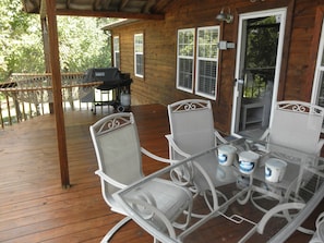 Covered deck now has 2 sets of wrought iron patio sets 