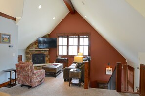 Living Room Area - Open living room area with a sofa sleeper, Smart TV, and cozy fireplace.