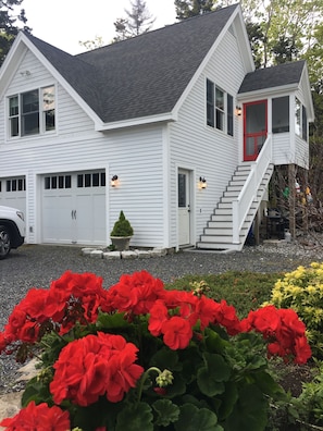 Ascend the stairs to your above-garage apt/cottage w/ocean views