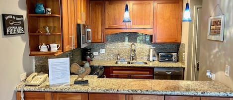 Remodeled kitchen with Cherry Wood Cabinets and Granite Counters