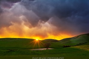 Enjoy a beautiful sunset view from the front porch taken by a local photographer