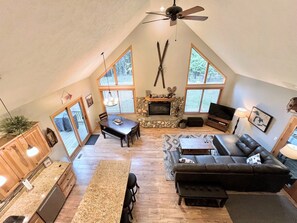 Large two-story great room with open floor plan, fireplace & plenty of light.