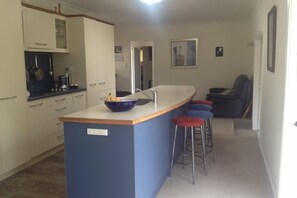 Kitchen with sofa bed in background