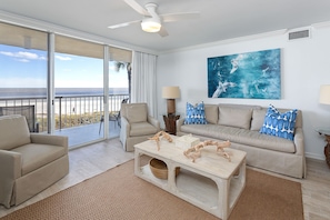 living room and view of beach/ocean from living room and balcony