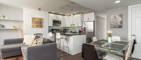 living room, dining area, and kitchen with breakfast bar