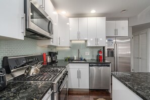 kitchen with stove top, microwave, fridge with water and ice dispenser