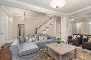 First floor TV area with view of front door and staircase