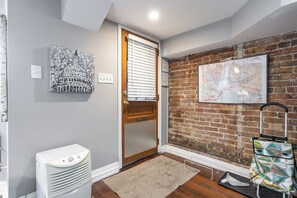 front door entry way with dehumidifier and grocery cart