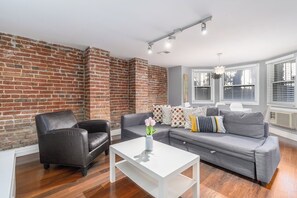 living room with sofa, arm chair, and coffee table