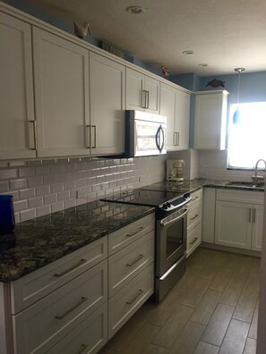 Updated Kitchen with beautiful granite, subway tile and window over sink.