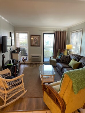 Ample seating in den and updated tile flooring throughout the condo and balcony 