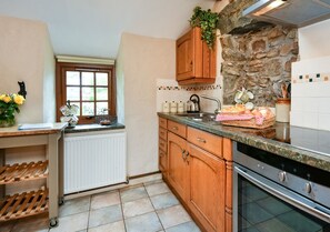 Fully equipped modern oak kitchen next to the dining room