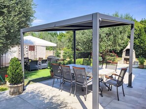 Plant, Property, Sky, Shade, Botany, Tree, Outdoor Table, Outdoor Furniture, Building, Chair