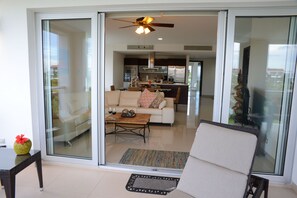 Double Sliding Glass Doors Lead From Sunny Living Area to Balcony